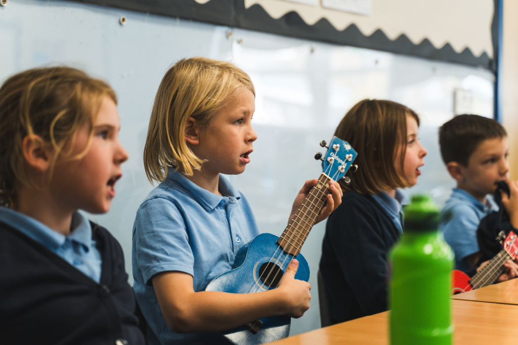 Girls singing and playing ukulele Girls singing and playing ukulele