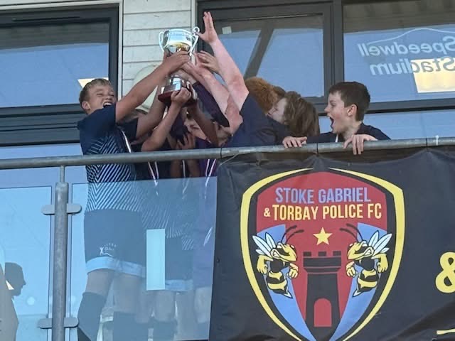 Oldway pupils at Football Finals night lifting a trophy